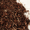 Dark brown wood mulch pieces, close-up view.

