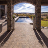 Stone patio pavers near a pool with a scenic view.
