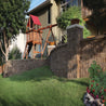 Harrington 6" RockFace Corner freestanding retaining wall in brown, creating a beautiful landscape.

