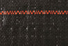 Black silt fence fabric detail, showing textured weave and orange marker stripe.
