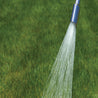 Aluminum watering nozzle spraying water onto a lush green lawn.

