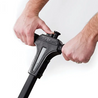 Close-up of a spreader's black plastic handle with on/off switch, showing easy operation.
