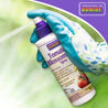 Gardener's gloved hand spraying 8 oz. tomato blossom spray; boosts fruit development.
