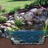 Pond filter system nestled in a natural rock garden, showcasing clear water and colorful fish.
