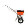 Orange 70lb capacity spreader with stainless steel frame and two large wheels, shown against a white background.
