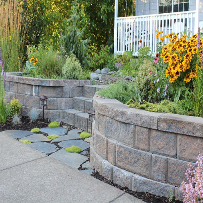 Curved retaining wall blocks create a tiered garden, path, and landscaping design.
