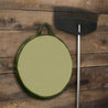 Round leaf storage bag with olive green fabric, hanging on a wooden wall.
