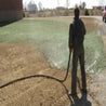Hydromulch application on bare soil, creating a green lawn.
