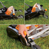 Reel mower with height adjustment lever, shown on a grassy lawn.
