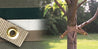 Beige tree strap with brass eyelets, secures young trees for support.

