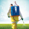 Person in protective gear applying treatment with a 3-gallon backpack sprayer in a field.
